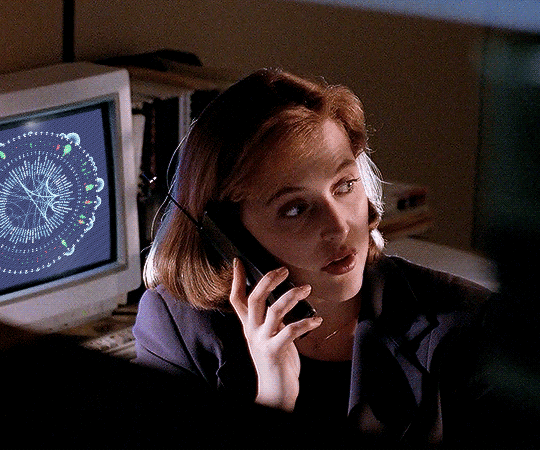 FBI agent Dana Scully is talking on the phone in front of a computer with the data visualization 'Every Writer of Chris Carter's TV Shows' open on the screen